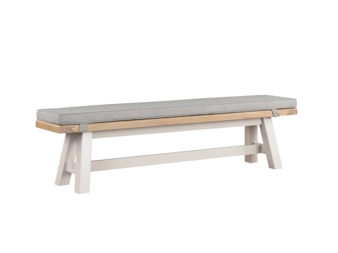 A wooden bench with grey painted A shape legs and a grey seat pad against a white background.
