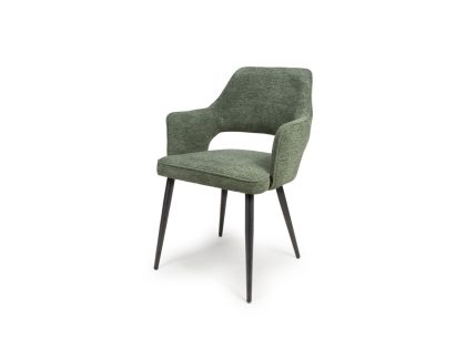 A green fabric dining chair with intergrated arms, a cut out on the back and four black metal legs.